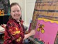 A woman paints at Group Supports Colour Gang at Distinctive Options Noweyung