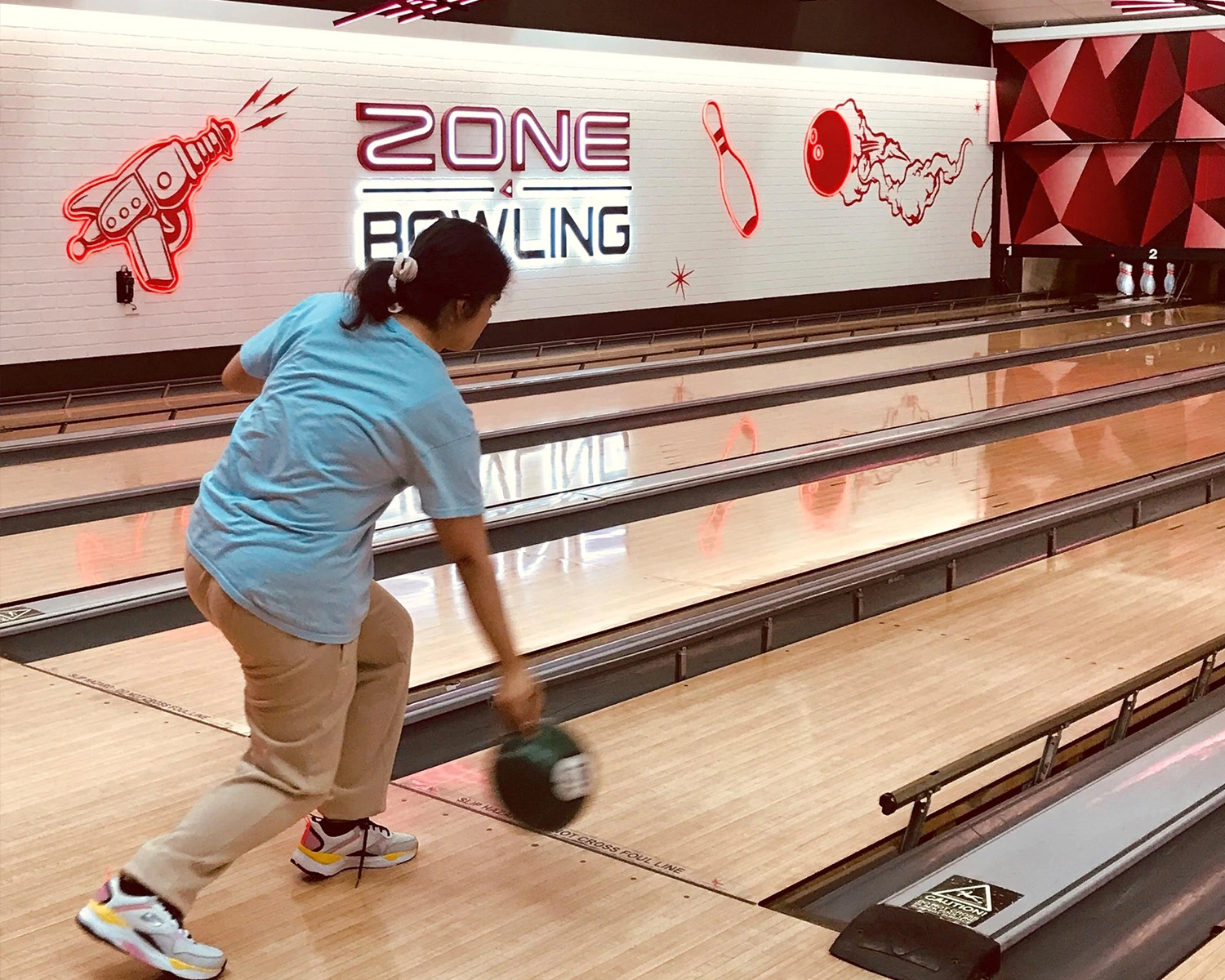 A woman plays ten pin bowling at Group support disability Distinctive Options