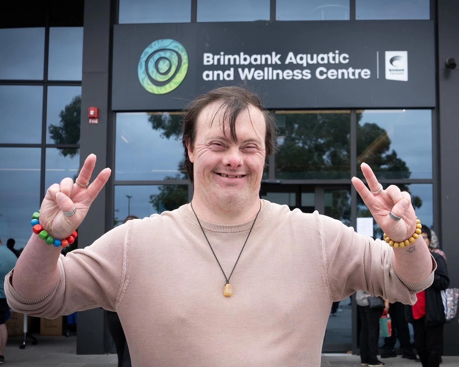 A man stands outside Brimbank sports Centre at NDIS registered disability supports Distinctive Options