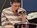 Lady singing into microphone while playing drums at Distinctive Options Noweyung