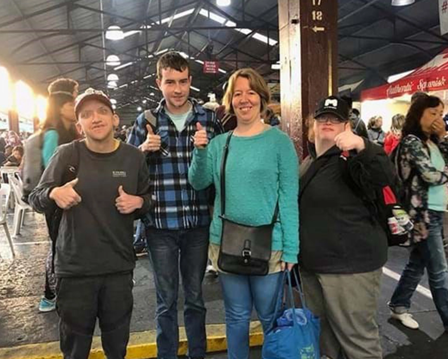 a group of people stand inside a market at NDIS registered disability service Distinctive Options