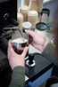 Supported Employee cafe staff serving a cappuccino at NDIS registered disability support Distinctive Options