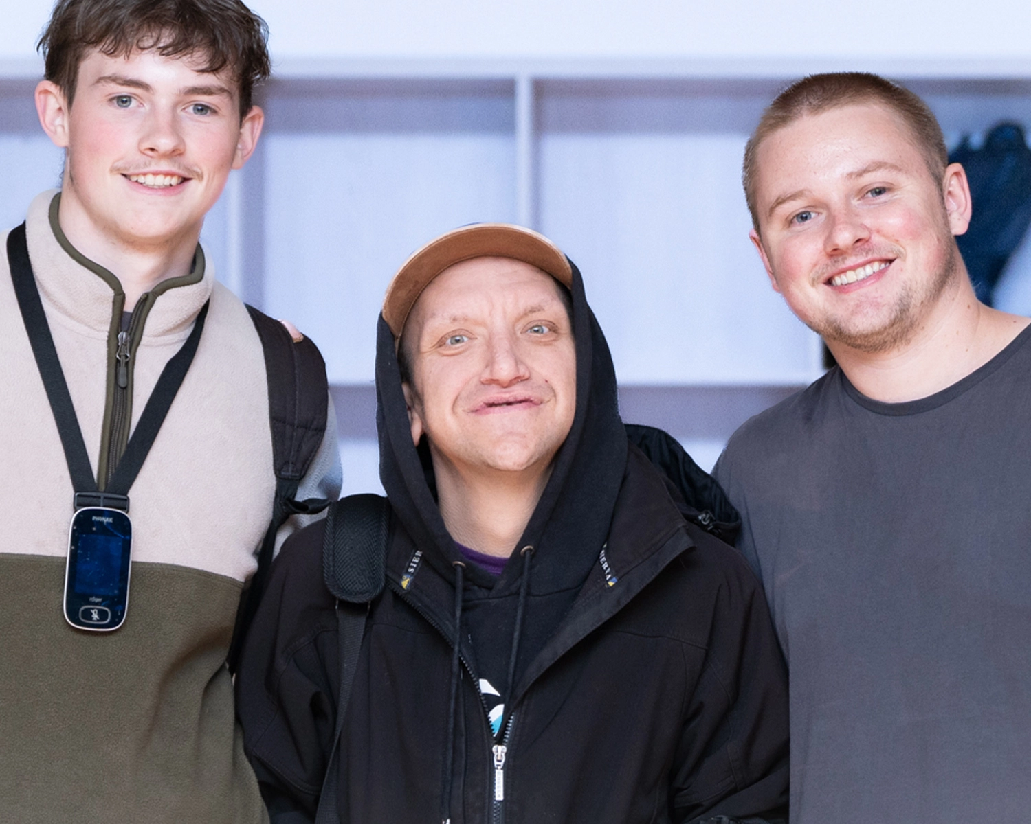 3 young men smile at NDIS registered disability support Distinctive Options