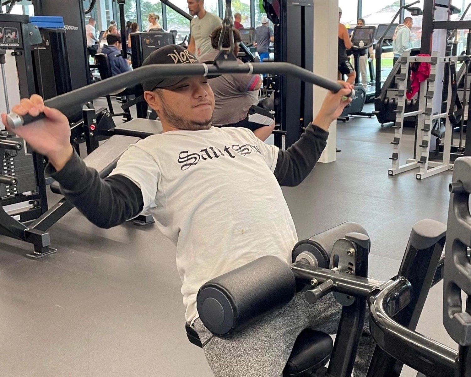 A man uses a pulley to do lat pull downs at a gymnasium at Distinctive Options Brimbank