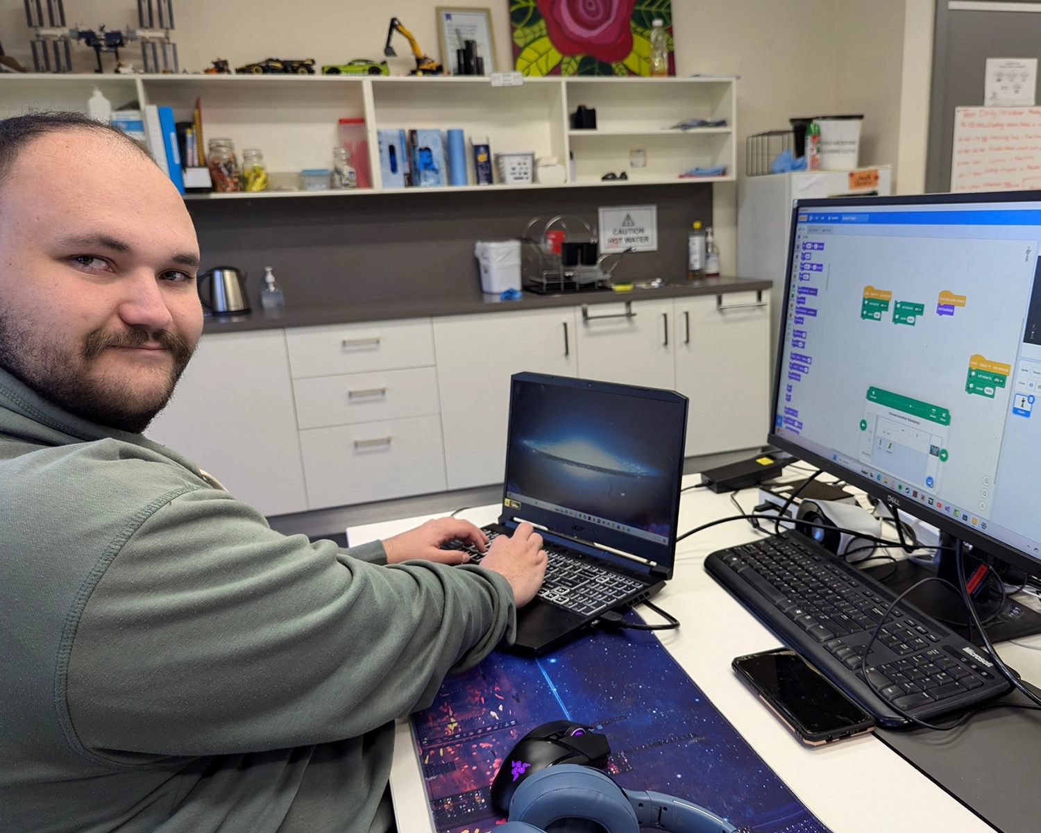 A man works at a computer at Group Supports IT and Photography at Distinctive Options Noweyung