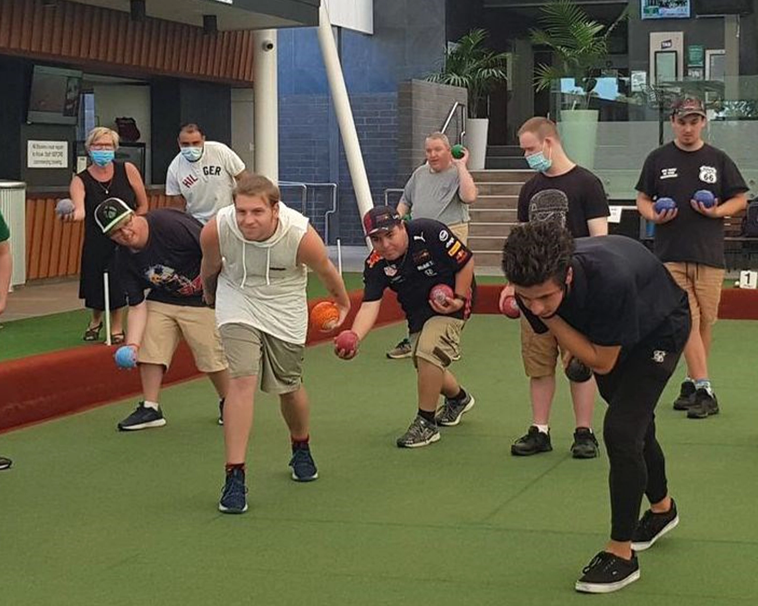 A group of people plan lawn bowls at NDIS registered disability service Distinctive Options