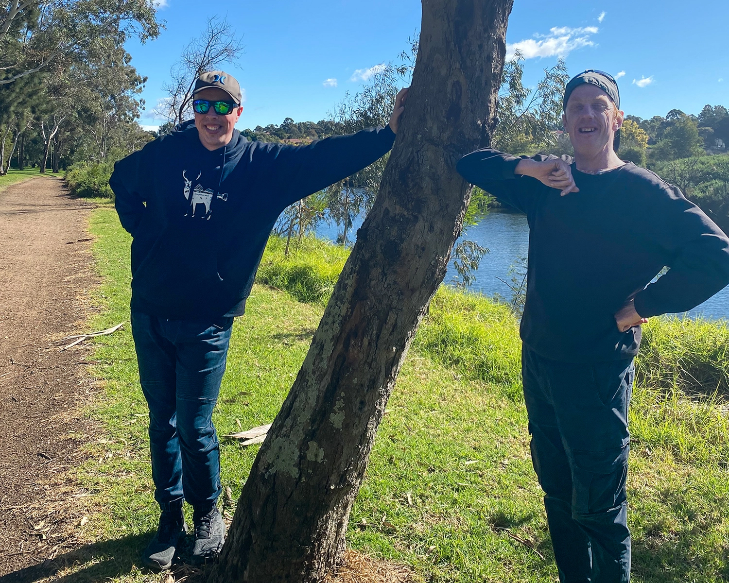 Two men stand by a tree at Wellness and relaxation at Distinctive Options Noweyung