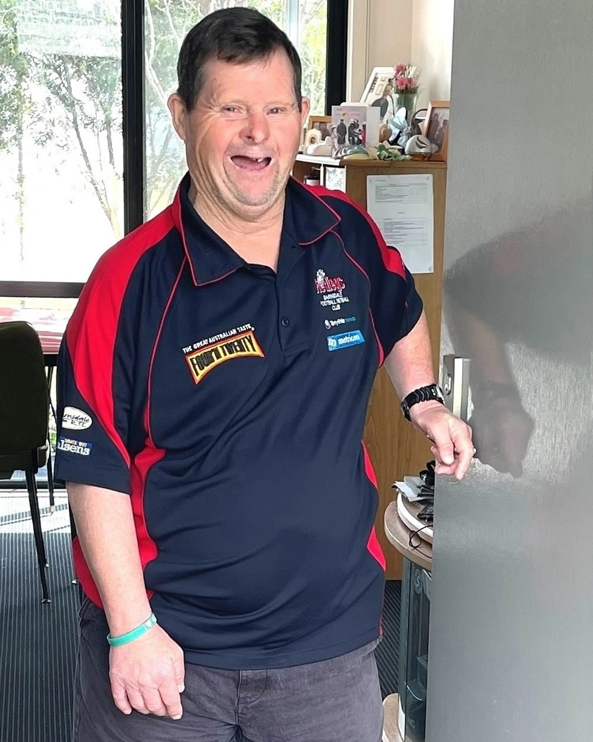 A man opens his front door at NDIS registered disability service Distinctive Options supported accommodation
