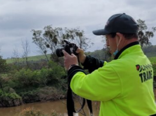 A man takes a photograph of Mitchell River Group Supports Photography program at Distinctive Options Noweyung