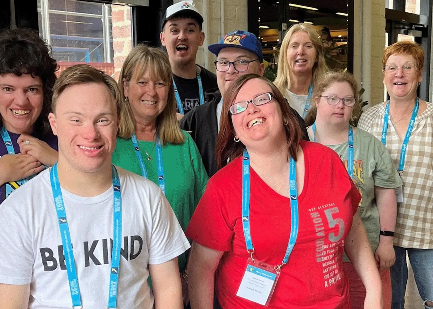 A group of people wearing lanyards at a conference