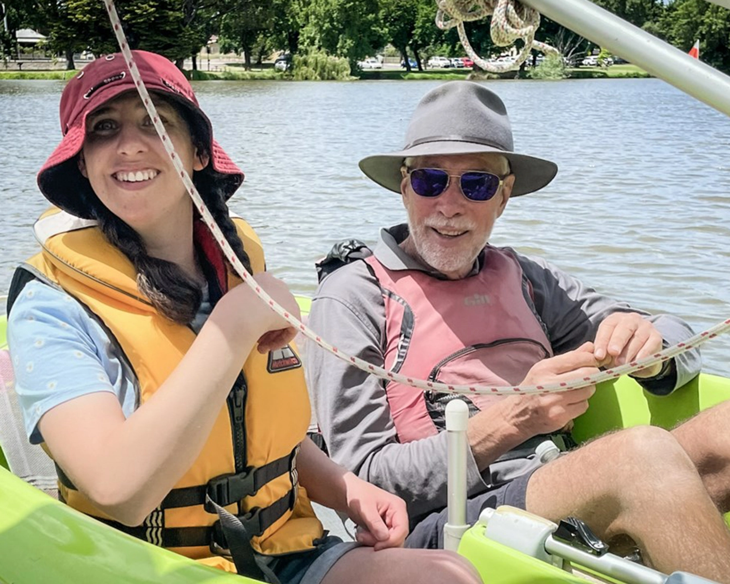 Two people sail in a small dinghy