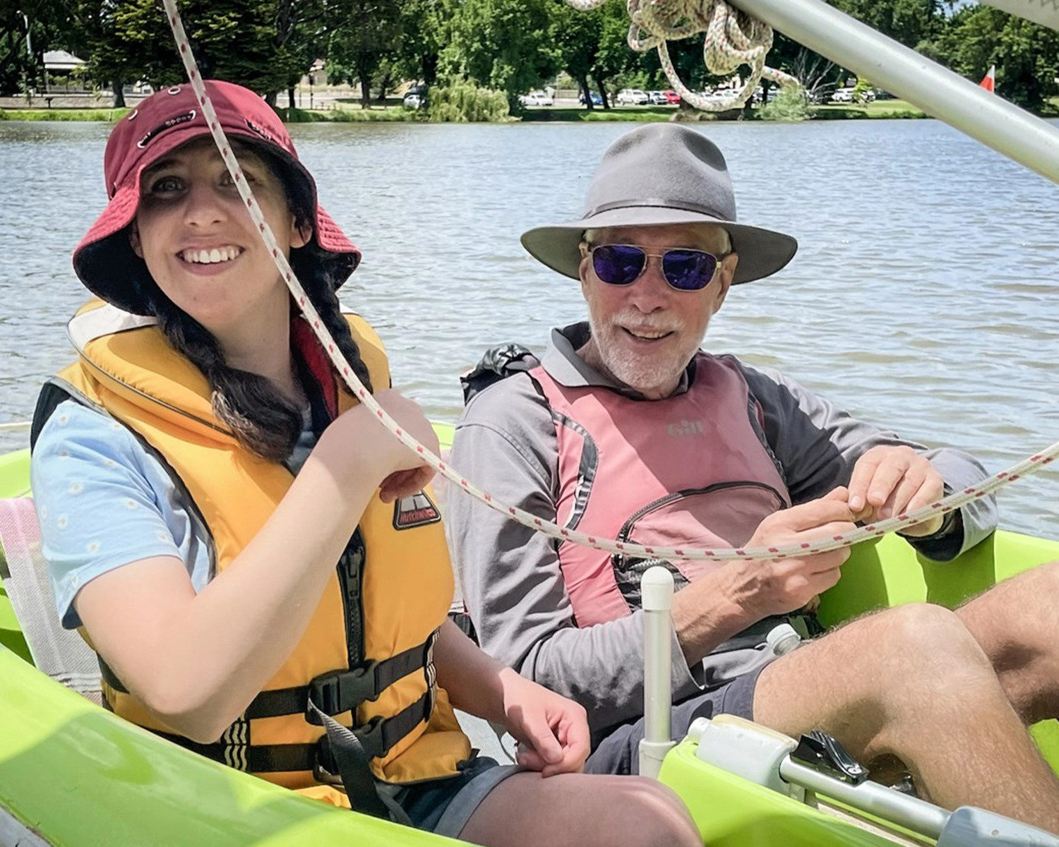 A woman sails in a small dinghy at NDIS registered disability service Distinctive Options