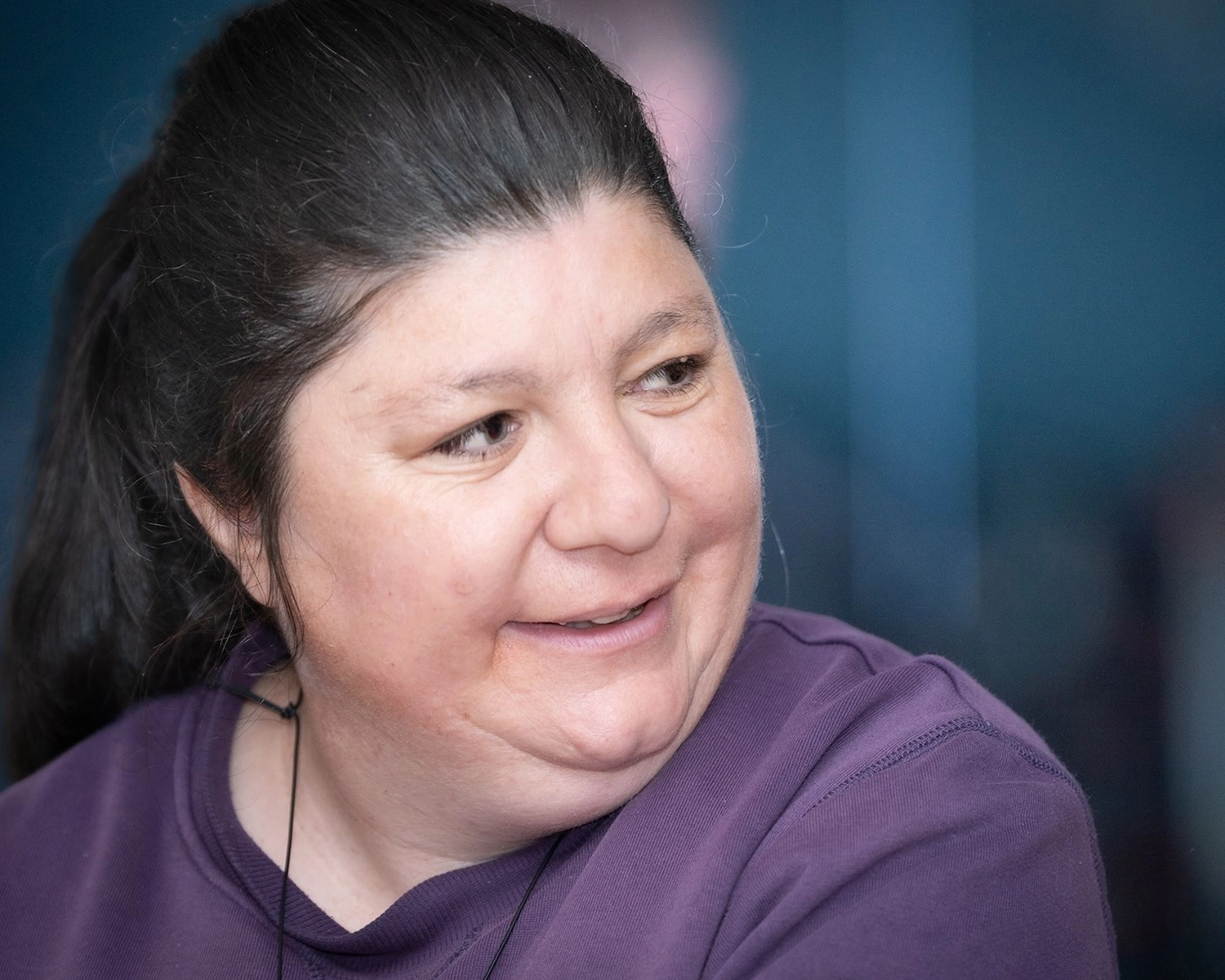 A woman smiles while at a dance class with individualised supports from Distinctive Options