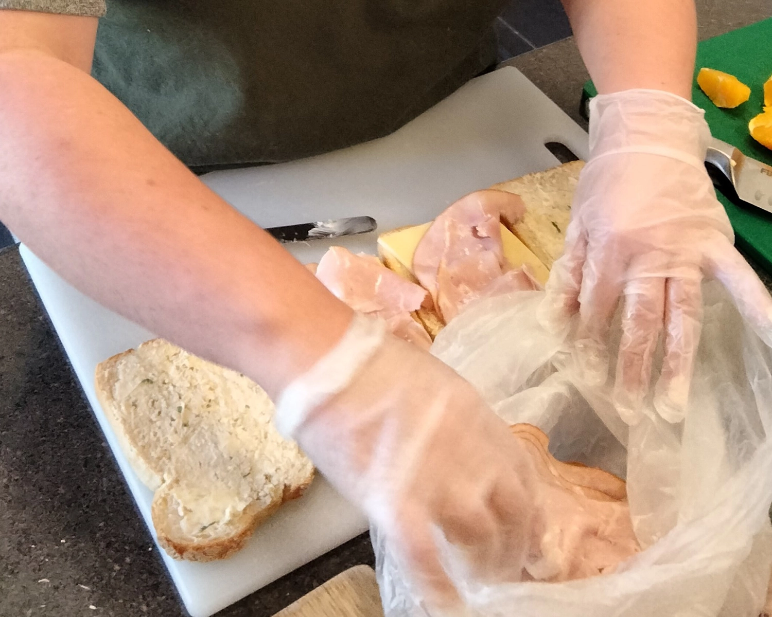 A pair pf hands make a sandwich at NDIS registered disability service Distinctive Options
