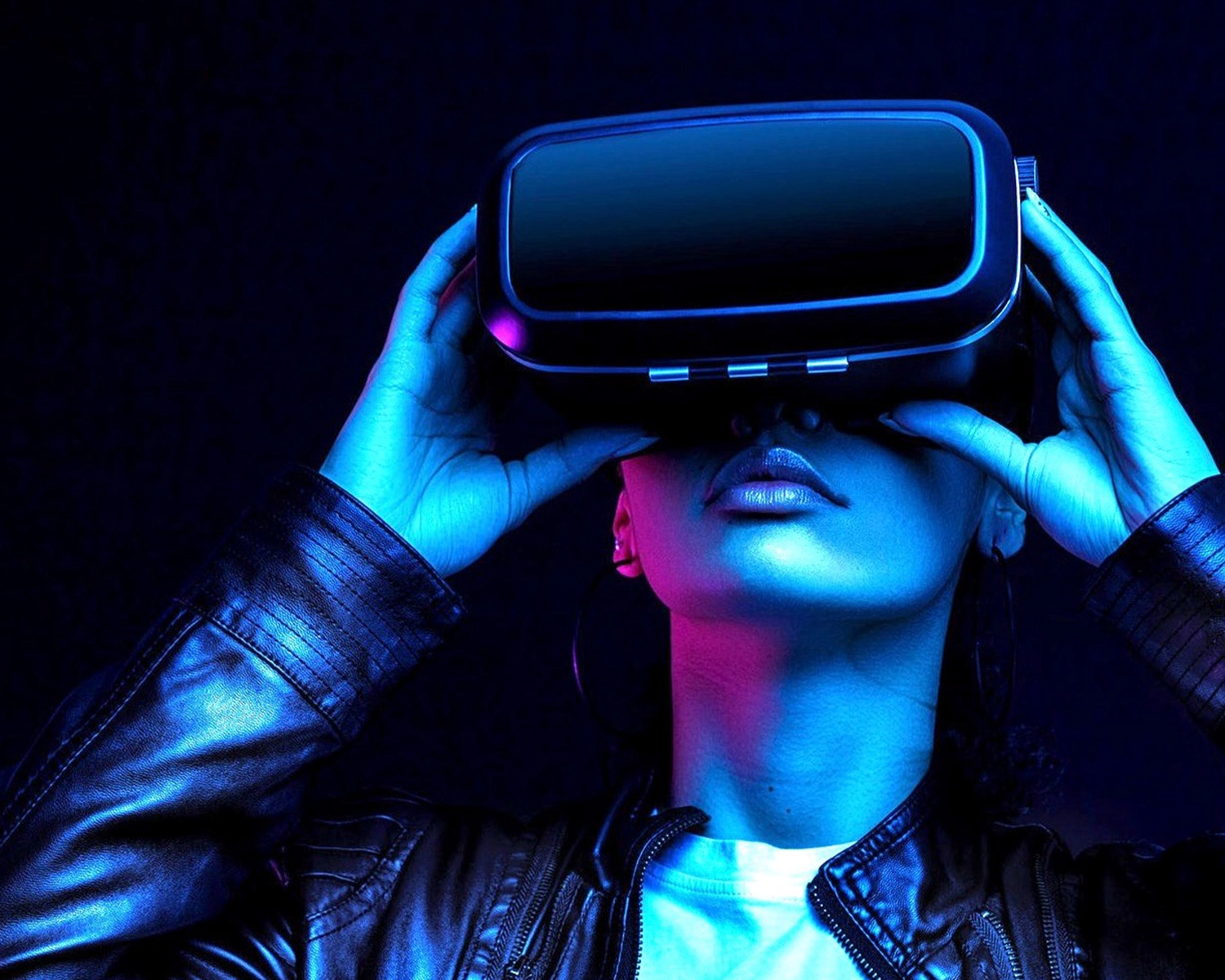 A woman holds a Virtual Reality headset to her eyes